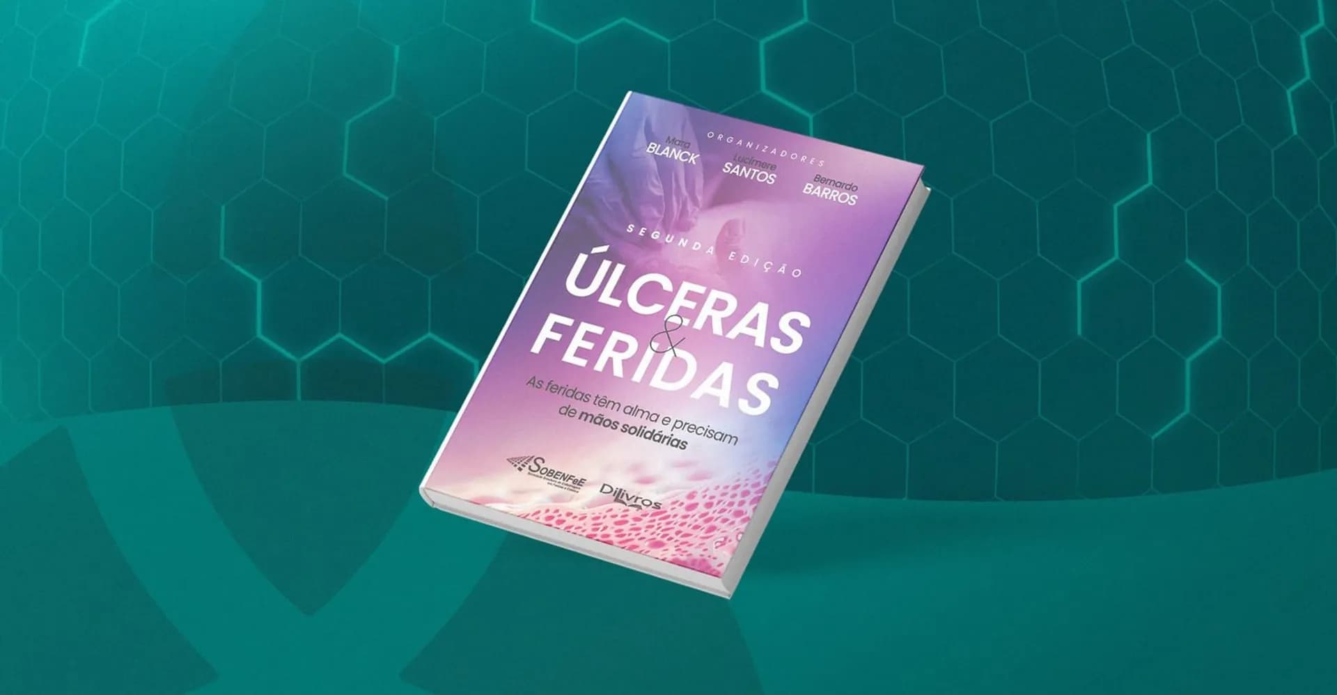 Capa da segunda edição do livro Úlceras & Feridas, inclinada sobre um fundo verde com padrão hexagonal.